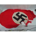 A small Nazi state flag - very torn and damaged