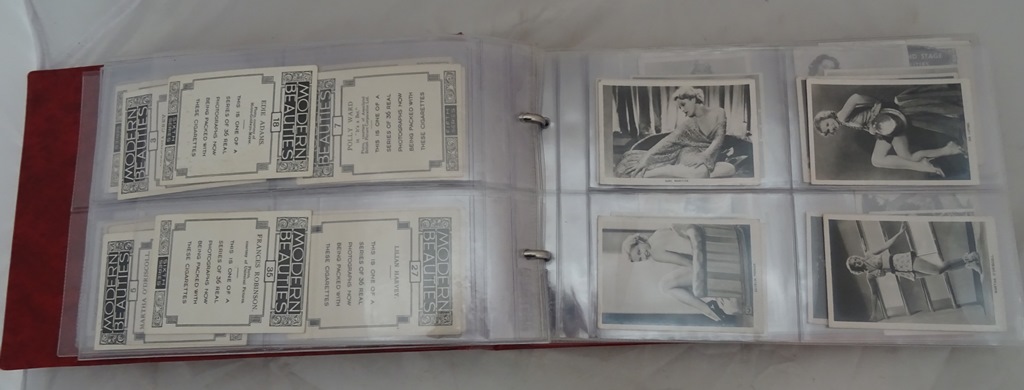 An album of photographic cigarette cards,