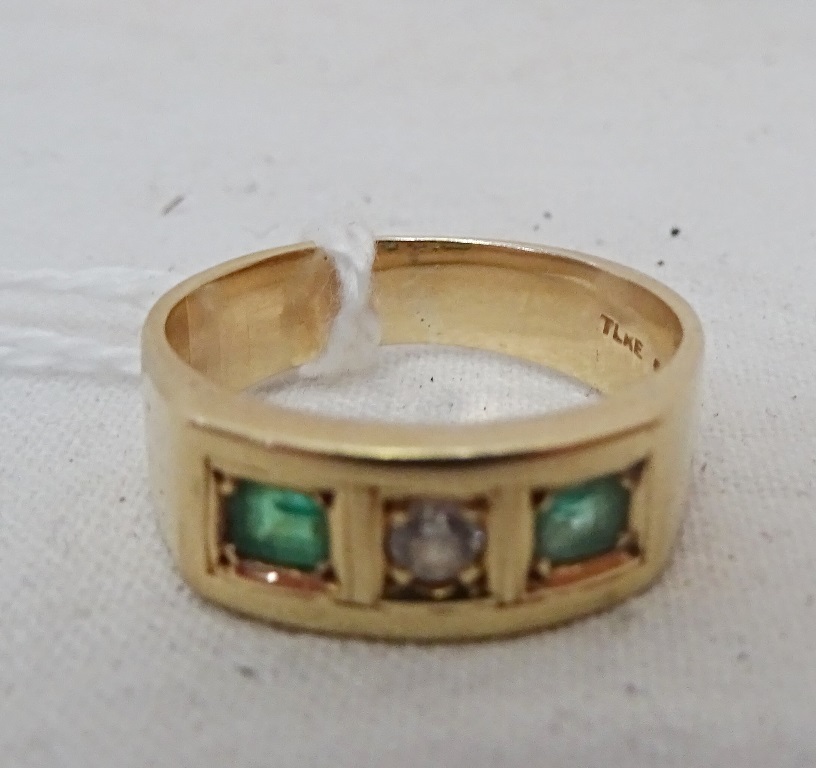A 14k emerald and white stone ring