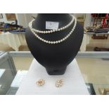 A double cultured pearl necklace with matching earring set in 14ct gold and 4ct gold clasp