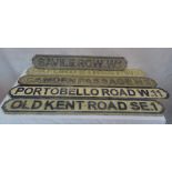 Five wooden road signs: 'Portobello Road', 'Camden Passage', 'Saville Road',