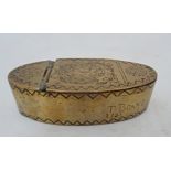 An 18th century brass snuff box in oval shape with lift-up mechanism with incised zigzag border and