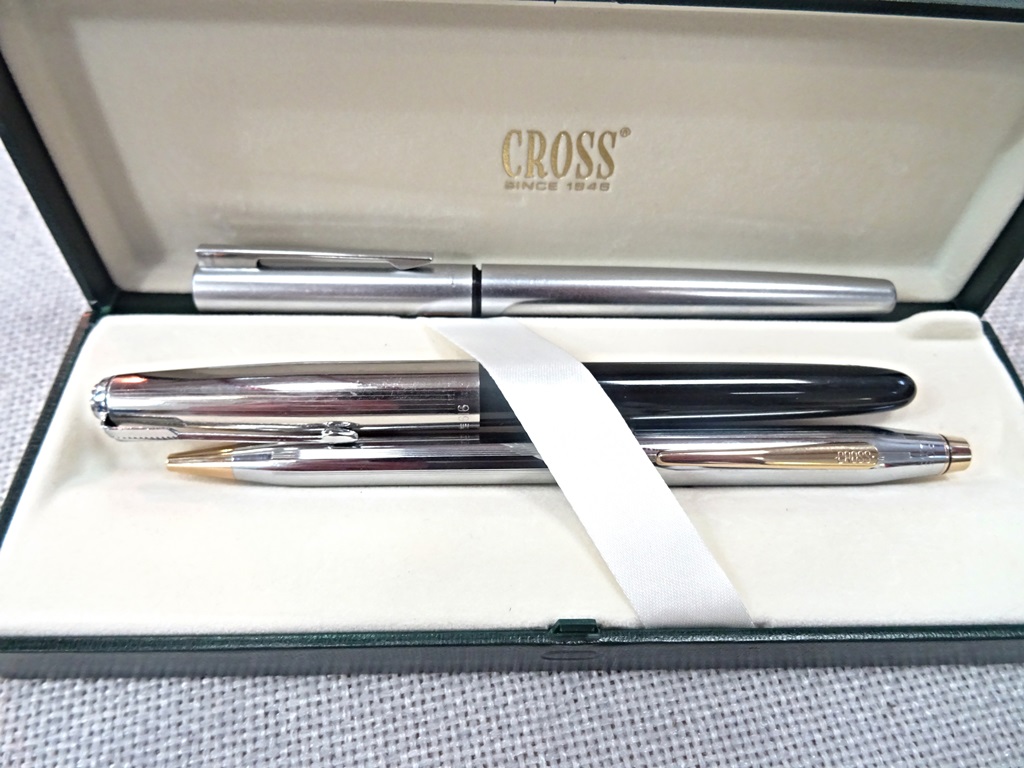 A cross steel and gold pen in case;