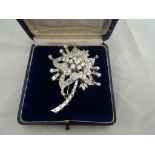 A floral diamond brooch of an aquilegia. Central stone spreads .50ct. Surrounded by 6x .