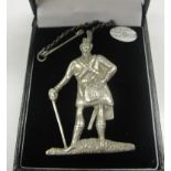A silver plaid brooch in the form of a Highlander