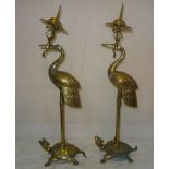 A pair of brass cranes standing on turtles