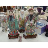 Three Chinese Ming-style figures on wooden stand