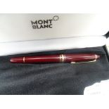 A Mont Blanc burgundy fountain pen;