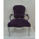 A silver framed open arm chair with purple fabric covering