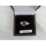 An 18ct gold emerald & diamond ring