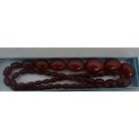 A cherry amber bead necklace, circa 1920, graduated beads on screwing fastener, nice even colour,