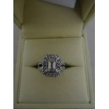 An 18ct white gold, emerald cut diamond solitaire (approx .