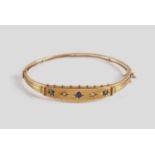 A Victorian 9ct diamond & sapphire bangle,