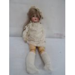 A German bisque headed doll in original clothing,