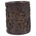 A Chinese Wooden Brushpot: 18th/19th century Finely and deeply carved to represent a high relief