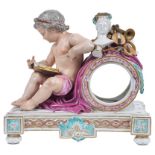 A 19th Century Continental Ceramic Clock Case: In the form of a seated Putti holding a pen and