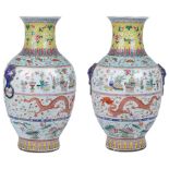 A Mirror Pair of Large Chinese Famille Rose Vases: 19th century The baluster-shaped bodies richly