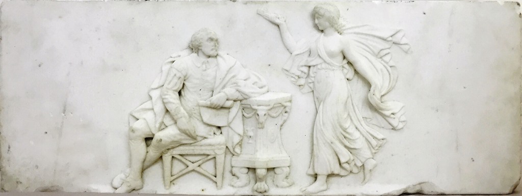 An Early 19th Century Carved Marble Frieze: Depicting a seated Shakespeare holding a pen and paper,