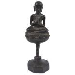 A Small Himalayan Bronze Figure: 14th century In the shape of a Buddhist figure sitting in prayer