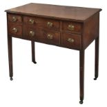 A George III Mahogany Desk: The rectangular cross-banded top above an arrangement of six drawers,