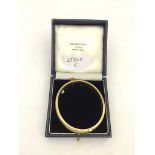 A 9ct garnet set bangle