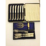 A cased HM silver pistol grip butter knives;