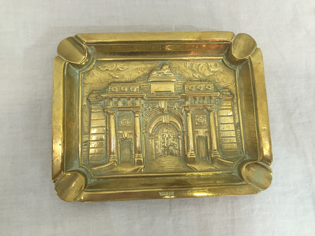 A brass ashtray depicting the Menin Gate