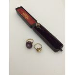 A 9ct gold mauve ring;