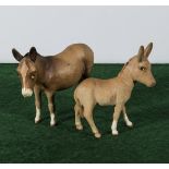 A Beswick donkey and foal both matt