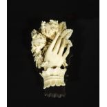 A Victorian ivory brooch modelled as a hand holding flowers