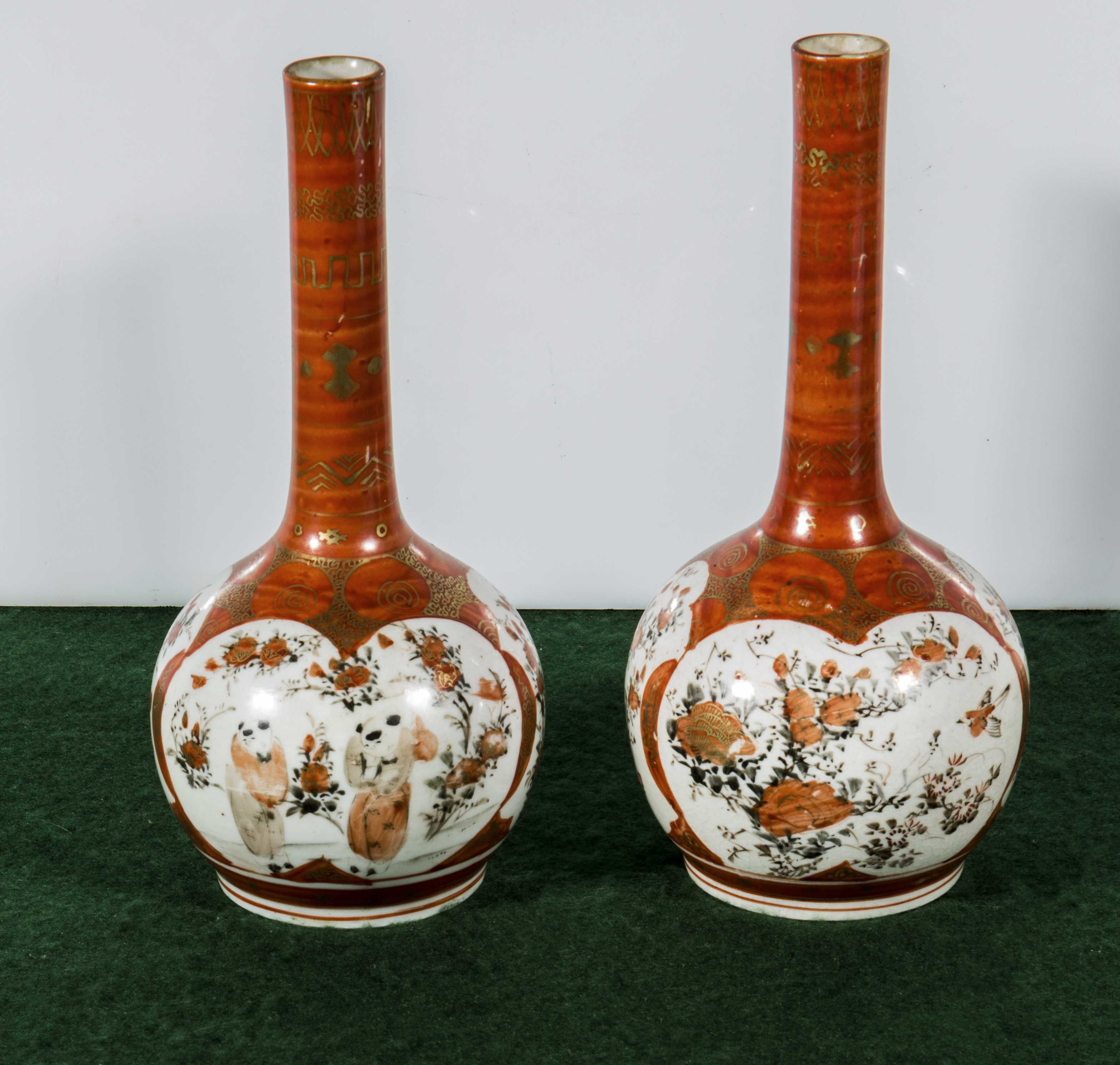 A pair of Kutani bottle vases, 23.5cm high