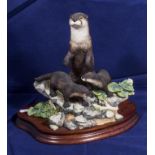 A Border Fine Arts figure group of otters