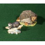 Two Border Fine Arts figure groups, Hedgehog and Otter on tree trunk