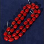 A string of coral coloured beads