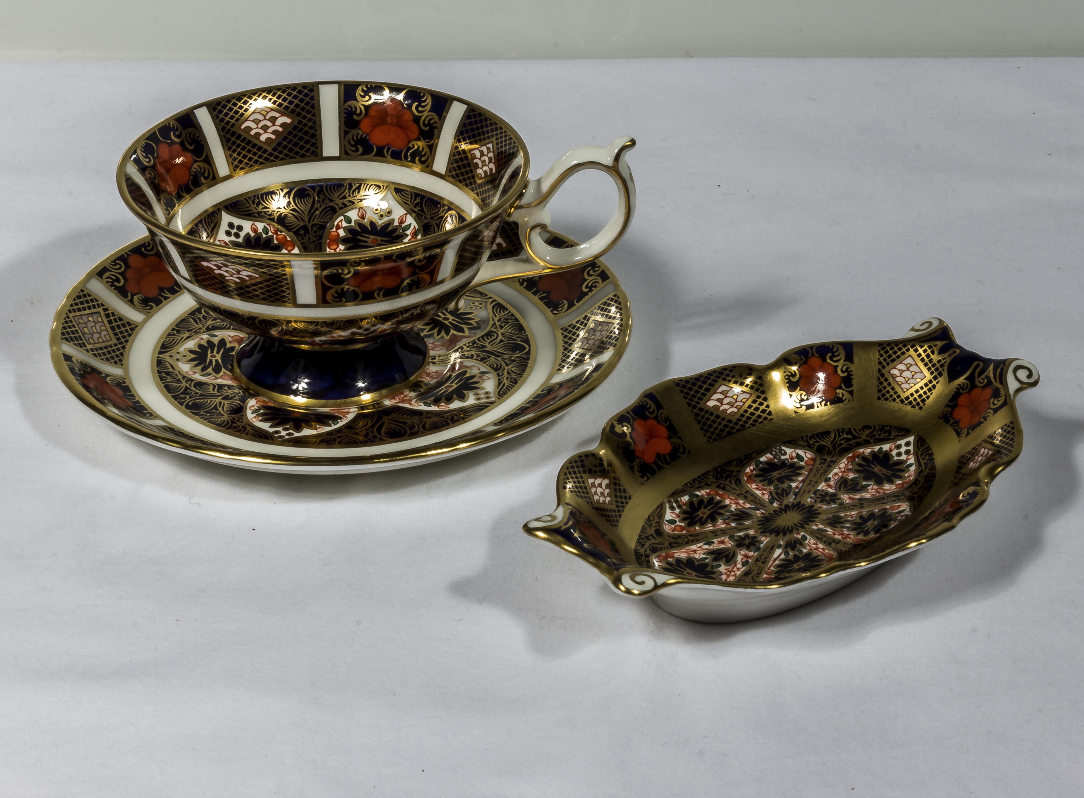 A Royal Crown Derby teacup and saucer together with a pin tray