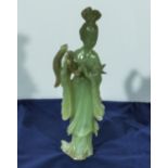 A Chinese green stone figure of Quan Yin