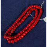 A string of coral coloured beads