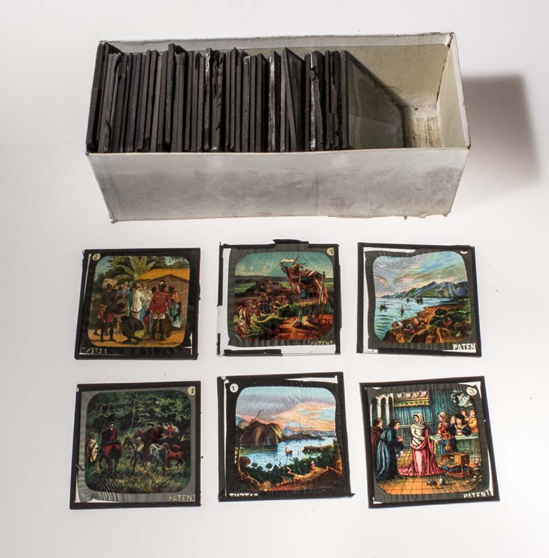 A box containing assorted coloured lantern slides