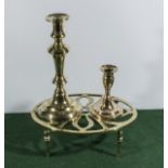 Two brass candle sticks and a brass trivet.