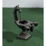 A bronze oil lamp.