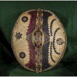 An antique African painted leather shield. Size 53cm x 39.5cm