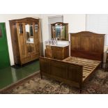 A three piece French bedroom suite comprising wardrobe, bed and washstand.