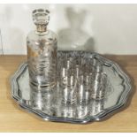 A decanter 10 shot glasses and a silver plated tray