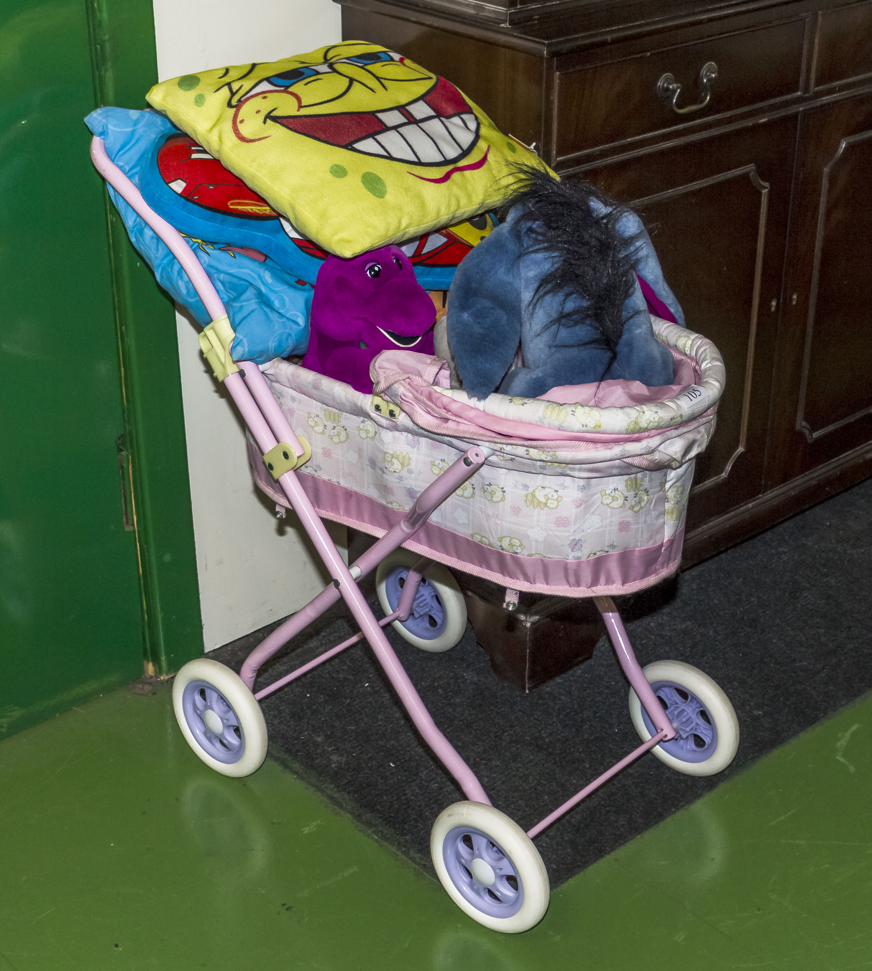 A toy pram and soft toys