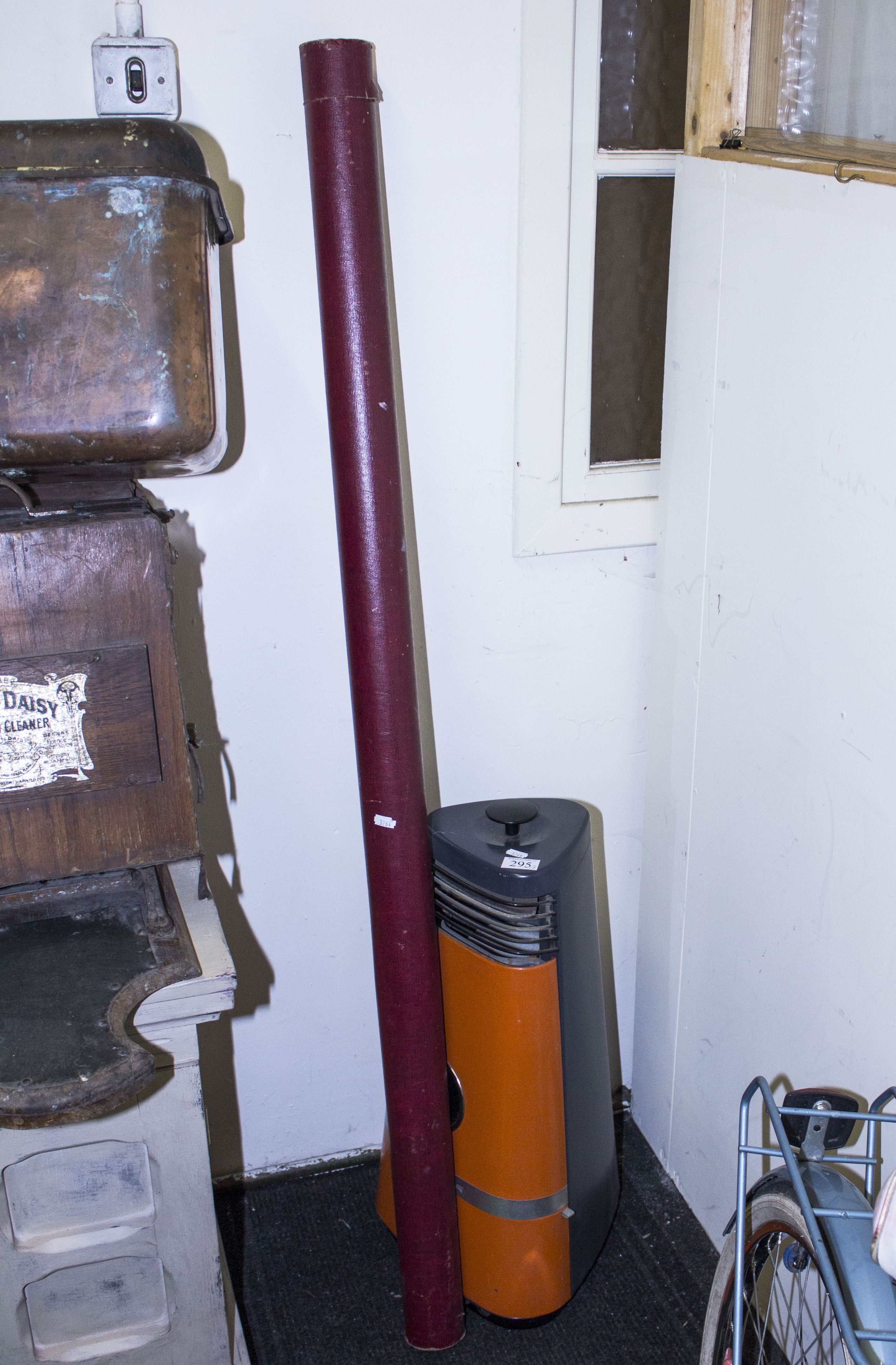 A vintage electric heater and a projector screen