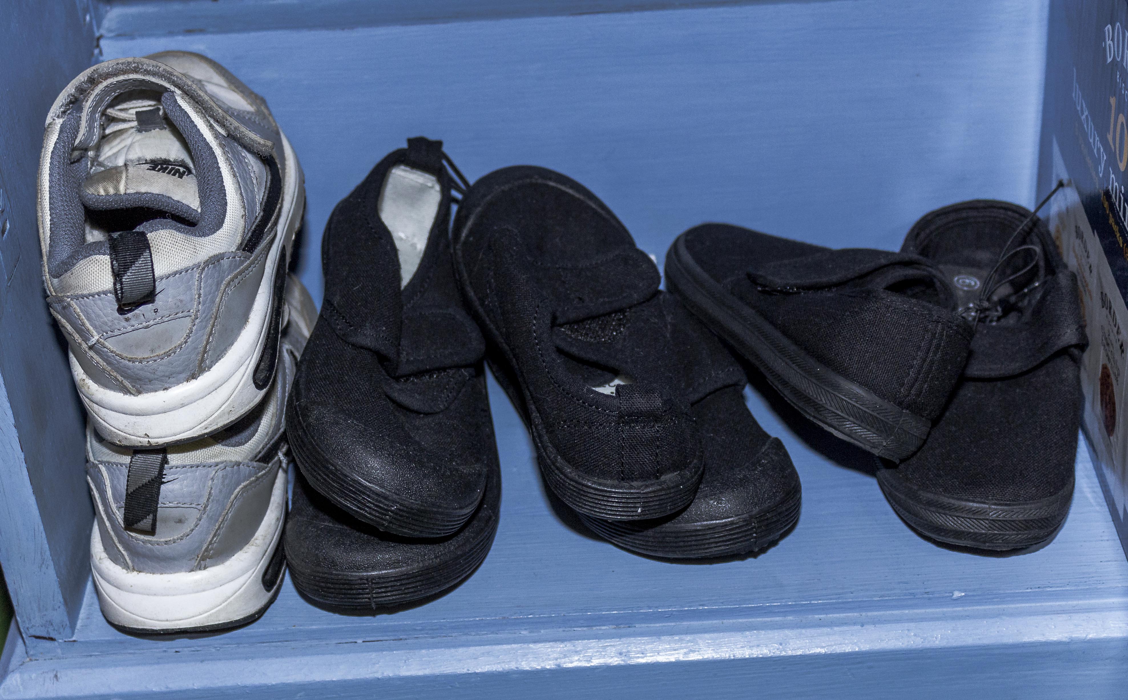 Three pairs of child's plimsolls and a pair of trainers