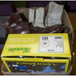 A box of lawn bowls and two pairs of vintage ice skates