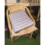 A wicker chair, footstool and a tray