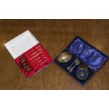 A cased set of tea spoons stamped Siam and two silver plated salts in a case