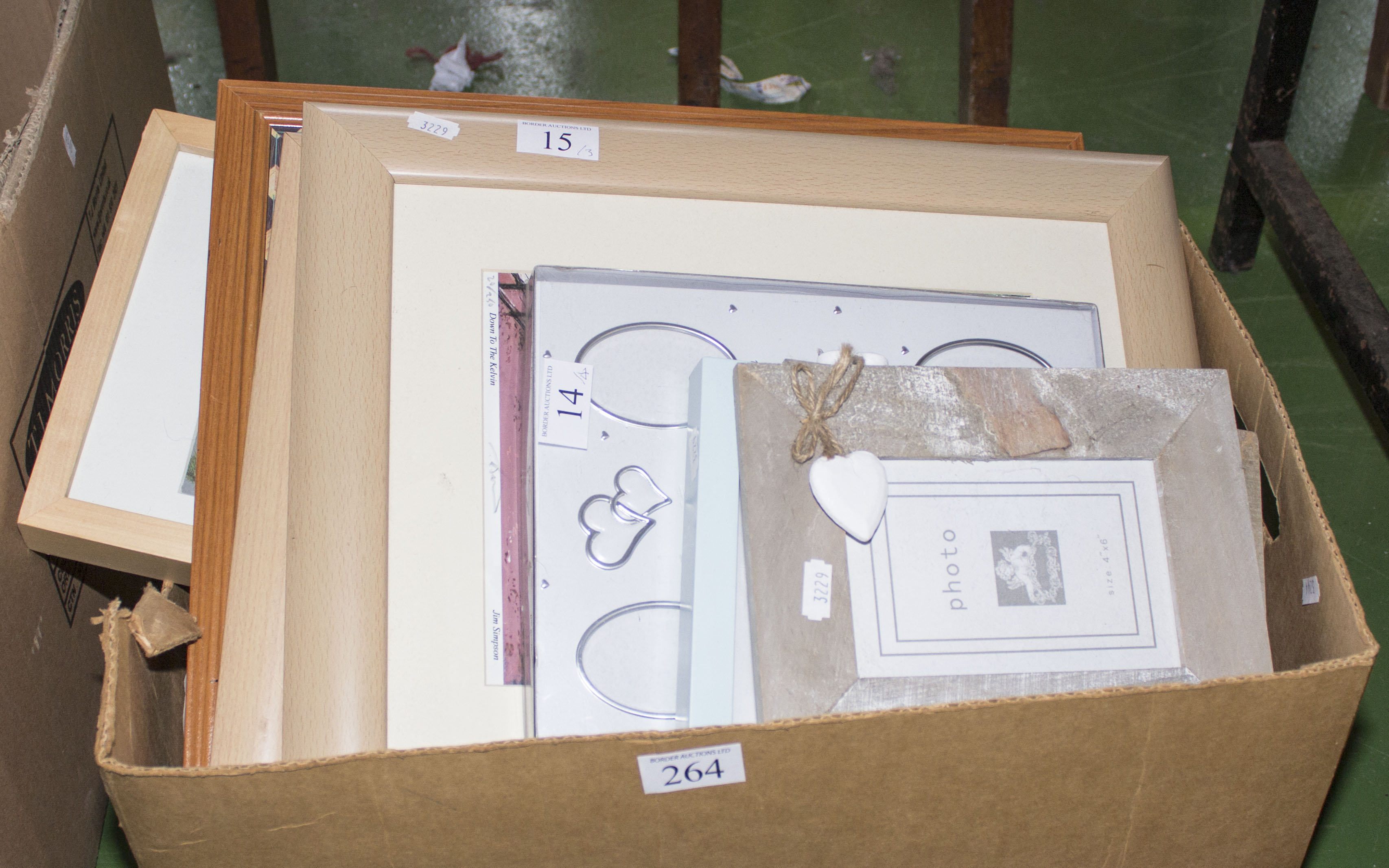 A box containing frames and prints